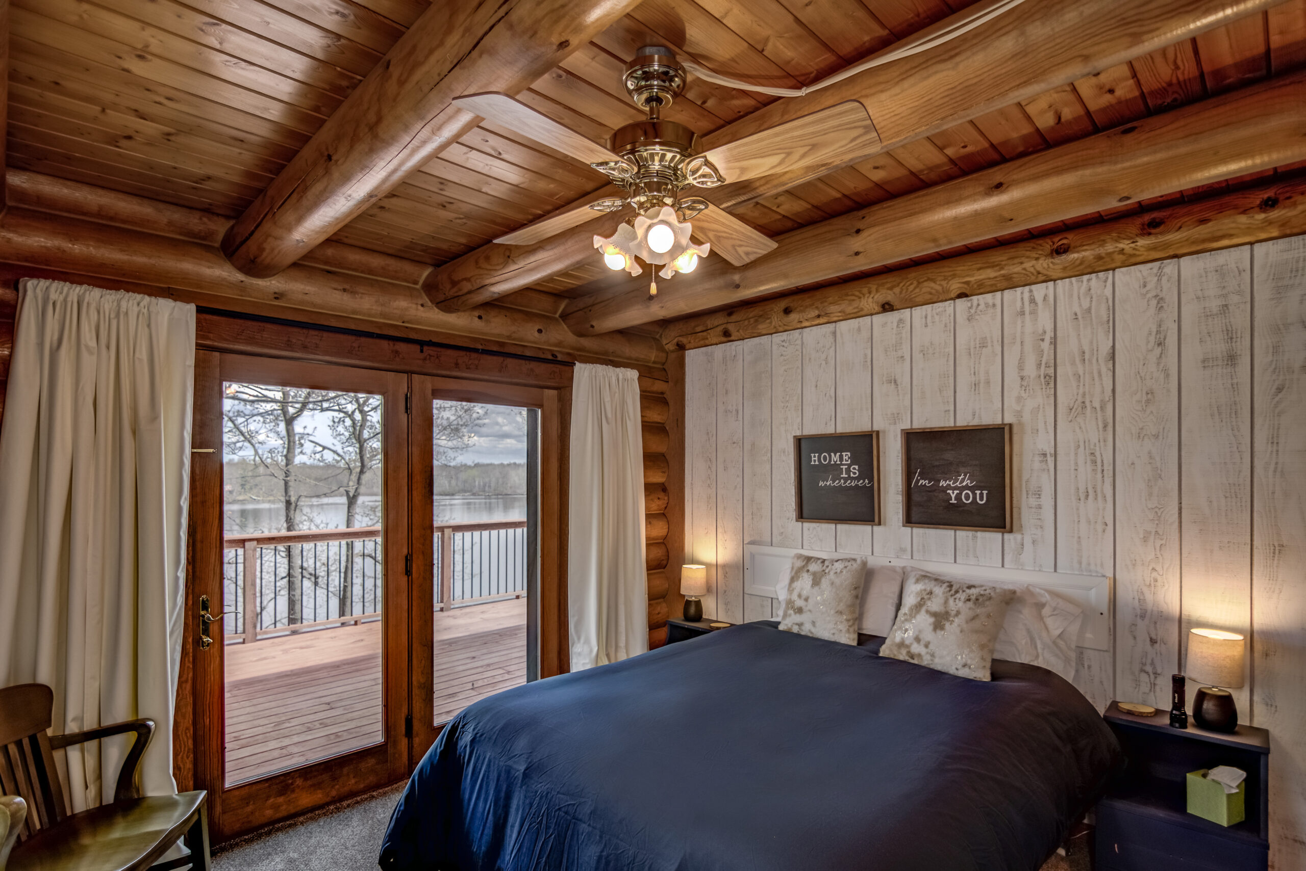 Bedroom with deck access and lake view